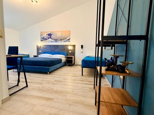 a hotel room with two beds and a table at Nautilus B&B in Scalea