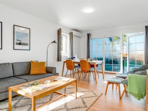 a living room with a couch and a table at Apartment Ama - 350m from the sea by Interhome in Østerby Havn