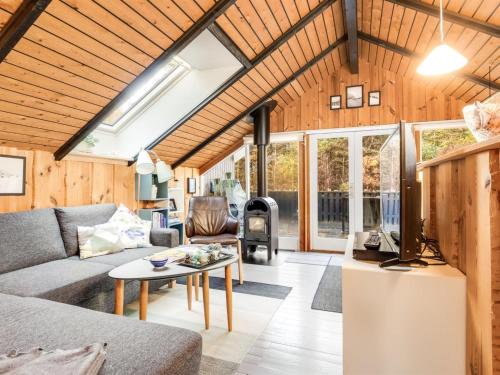 a living room with a couch and a table at Holiday Home Else - 470m from the sea by Interhome in Østerby Havn