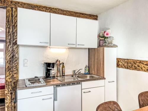 a kitchen with white cabinets and a sink at Apartment Therese by Interhome in Mirow