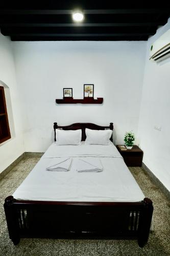a bedroom with a large bed in a room at Idanazhi the corridor in Kozhikode