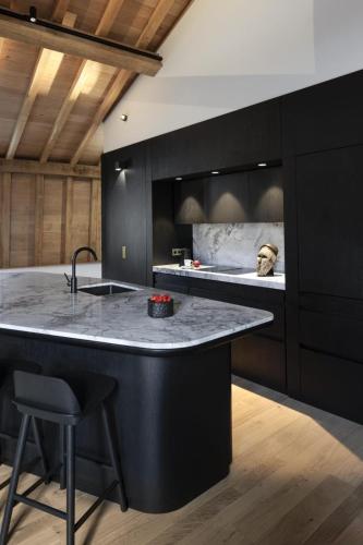 a kitchen with a large island with a counter top at Les Suites by Cave Vauban in Dijon