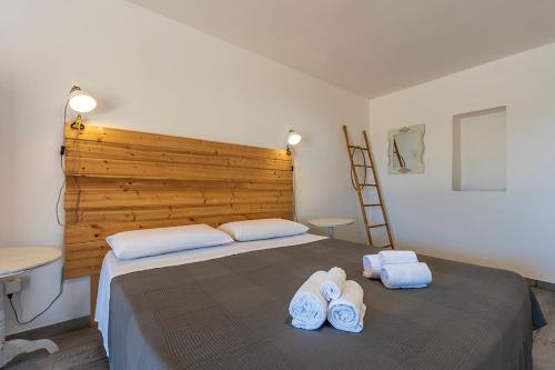 a bedroom with a large bed with towels on it at Villa fronte mare nel Salento in Castro di Lecce