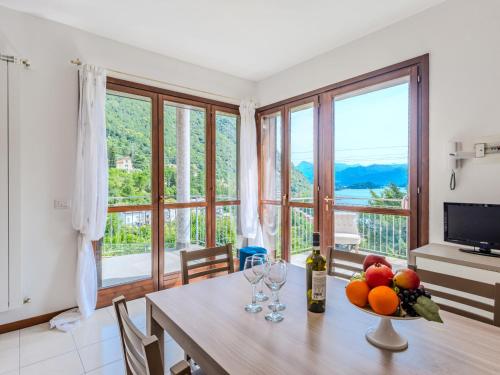 a dining room with a table and a large window at Apartment Borgo Castello-9 by Interhome in Argegno