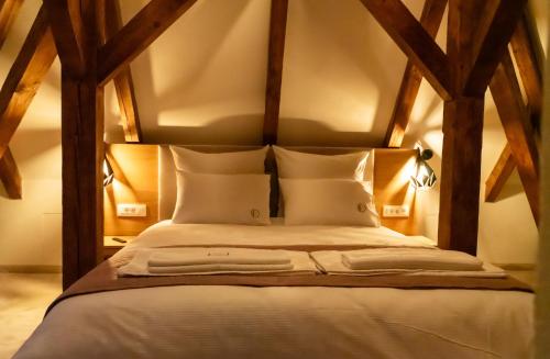 a bedroom with a large bed with wooden beams at Castelului Boutique-Old Town-Free Private Parking in Braşov