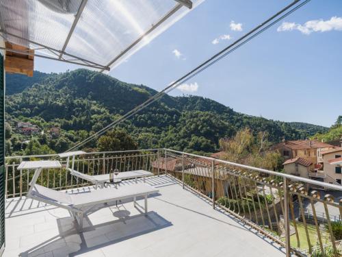 a balcony with a table and a view of mountains at Holiday Home Casa Gli Aranci by Interhome in Montignoso