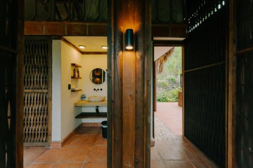 a hallway leading to a bathroom with a sink at Sandagua hotel in Puerto Triunfo