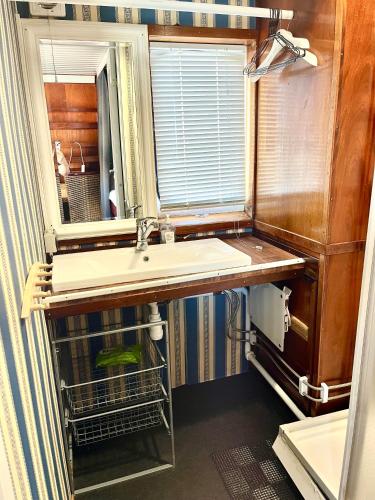 a bathroom with a sink and a mirror at Lofoten Cruise & Hotel in Svolvær