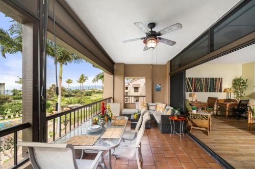 a screened in porch with a table and chairs at Kaanapali Royal H303 · KRL H303 Spacious 2BD Condo on Maui Golf in Lahaina