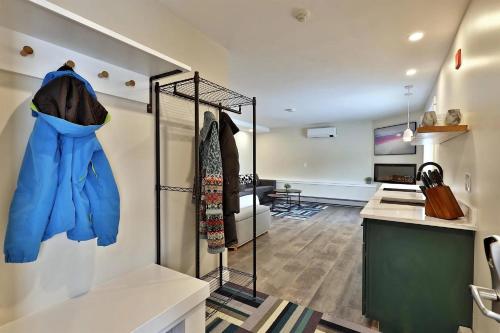 a room with a display case with blue coats at Stylish Studio for 4 with EV Charger, Summer Pool & Shuttle Access in The Woods