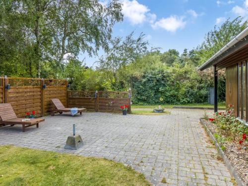 a patio with two chairs and a bench at Holiday Home Naema - 500m from the sea by Interhome in Østerby Havn