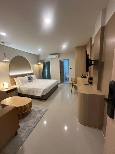 a hotel room with a bed and a living room at Abundant Eco Hostel in Laguna Phuket