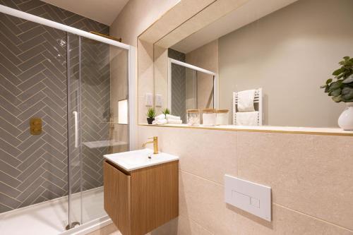 a bathroom with a sink and a shower at Apartment Three Pelican House in Bournemouth
