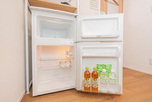 an open refrigerator with drinks inside of it at Kamakura no Nikki in Kamakura