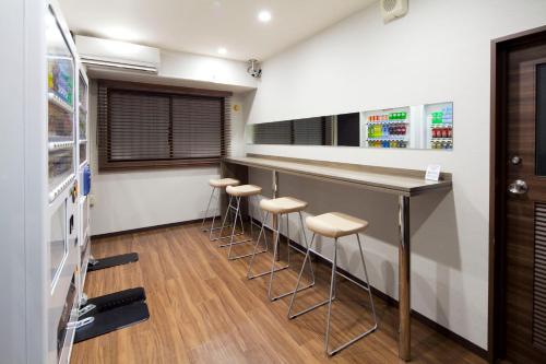 a bar with stools in a waiting room at HOTEL MYSTAYS Ueno Inaricho in Tokyo