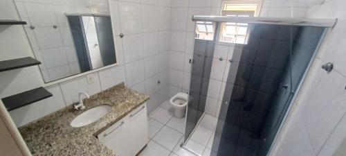 a bathroom with a shower and a sink and a toilet at Casa próximo á Unesc em Criciúma-SC in Criciúma