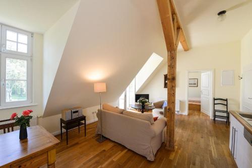 a living room with a couch and a table at Wohnung Im Zweiten Obergeschoss Des Gutshauses in Neuenkirchen