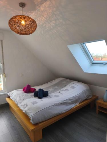 a bedroom with a bed with two bags on it at L'écrin champêtre, séjour chic et cosy in Waldolwisheim