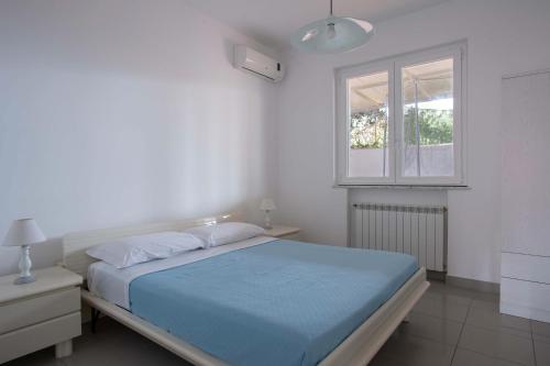 En eller flere senge i et værelse på Villetta San Leone con giardino