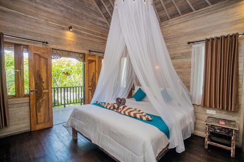 Postel nebo postele na pokoji v ubytování D'Gume Villas Lembongan