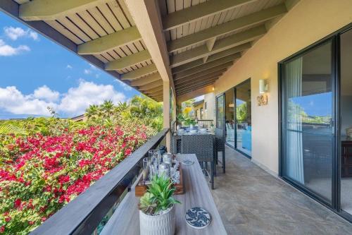 a balcony with a table and flowers on it at Wailea Ekahi 40E · WEK 40E Dream Getaway w AC Pools Beaches Golf in Wailea