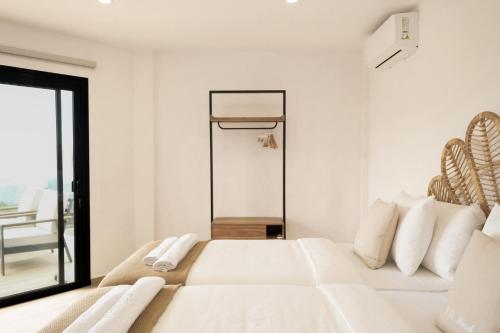 a white bedroom with a bed and a basketball hoop at Finca el Moral by Huskalia in Los Llanos de Aridane