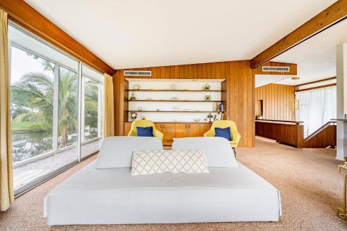 two beds in a room with a large window at Waterfront Home by Ralph Twitchell in Sarasota