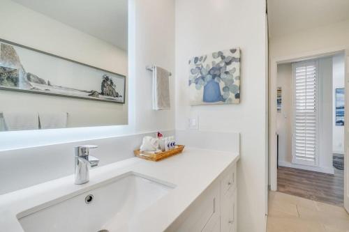 a white bathroom with a sink and a mirror at Wailea Ekahi 21A · WEK 21A Remodeled Wailea Condo Pool AC Near B in Wailea