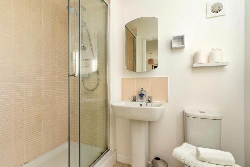 a white bathroom with a sink and a shower at Finest Retreats - Ffordd Y Meillion in Llanelli