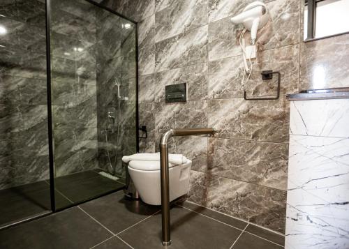 a bathroom with a shower and a toilet at Suya Studios by HolidayKeys in Karavas