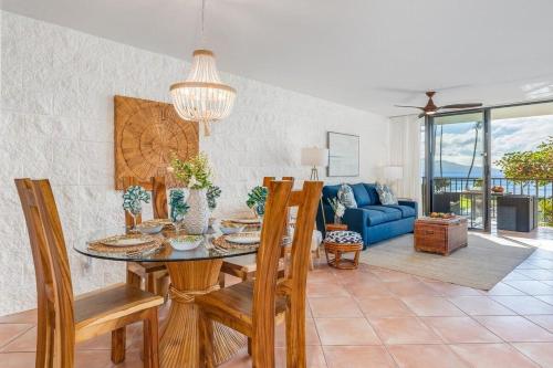 a dining room with a table and chairs at Kanai A Nalu 211 · KAN 211 Remodeled OceanFront 2BD for Whale Wa in Wailuku