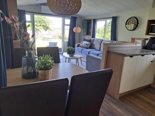 a kitchen and living room with a table and a couch at B&B Landlust in Ons Belang