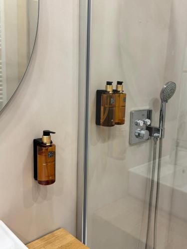 a shower with two soap dispensers on the wall at Casa Maristany in Camprodon