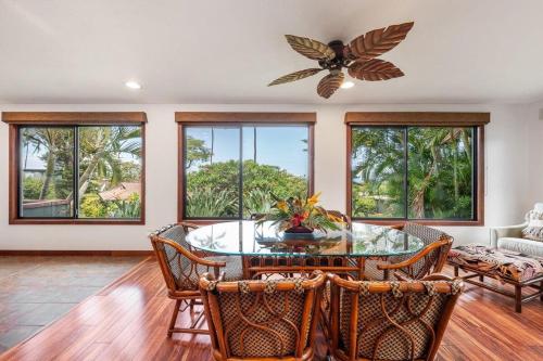 a dining room with a table and chairs and windows at International Colony Club 23 · ICC 23 3BD Kaanapali Plantation C in Lahaina