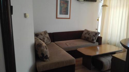 a living room with a couch and a table at Family Hotel Rositsa in Sevlievo
