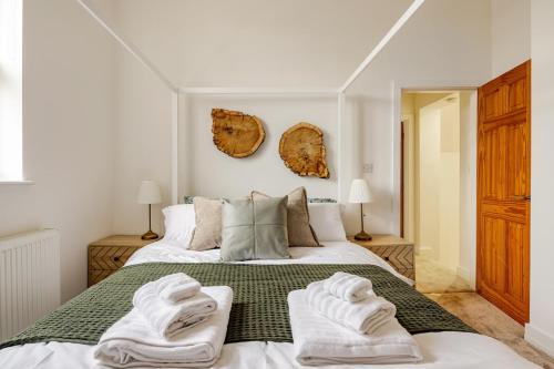 a bedroom with a bed with towels on it at Perfect Base for Work or Leisure Unique Two-Bed in Irlam