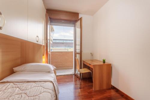 une chambre avec un lit, un bureau et une fenêtre dans l'établissement Parking & Free WiFi - Functional apartment, à Modène