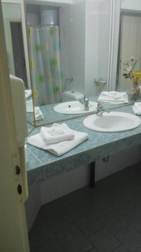 a bathroom counter with two sinks and a mirror at Family Hotel Rositsa in Sevlievo