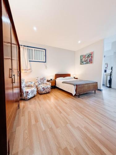 a bedroom with a bed and a couch at Costa Cabral Porto Flat in Porto