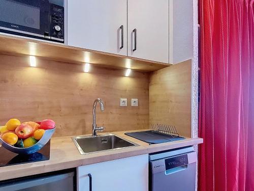 a kitchen with a sink and a bowl of fruit at Studio Les Olympiades-23 by Interhome in Val Thorens