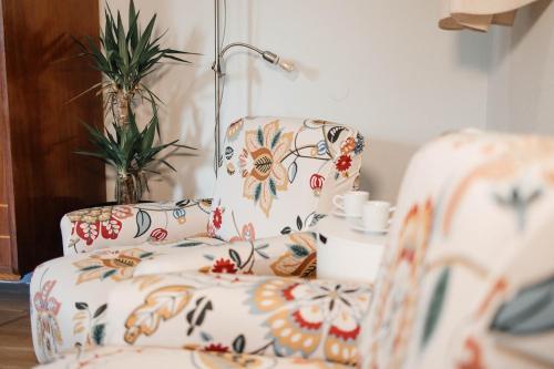 a living room with a chair and a lamp at Costa Cabral Porto Flat in Porto