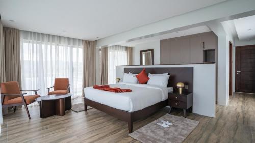 a hotel room with a bed and a table and chairs at The 67 Escape, Elementaita in Gilgil