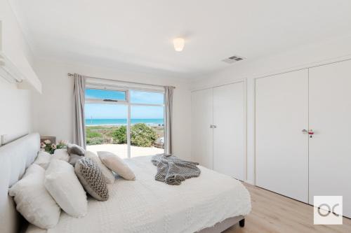 a bedroom with a bed with a view of the ocean at Amazing Views in Middleton