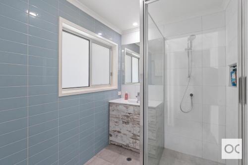 a bathroom with a glass shower and a sink at Amazing Views in Middleton