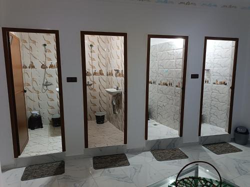 a group of four mirrors in a bathroom at Dar lkbira Azazoul in Taghazout