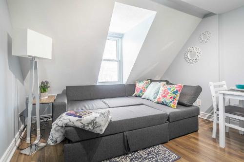 a living room with a couch and a table at Urban 1BR Gem with Kitchen, Smart TV & Workspace in Ottawa