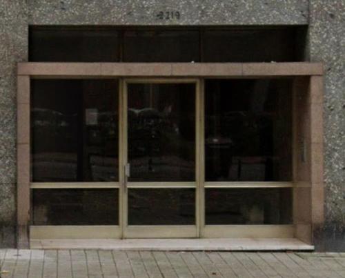 a large glass door in a building with a brick at Costa Cabral Porto Flat in Porto