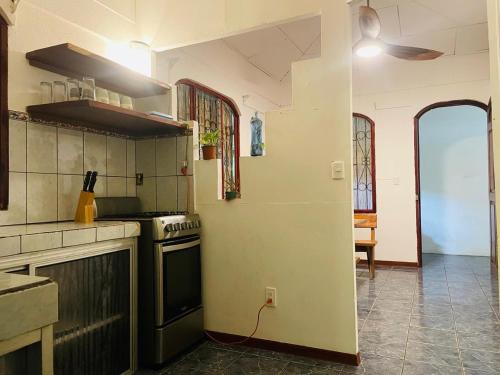 a kitchen with a stove top oven in a room at Maudie in Santa Teresa Beach