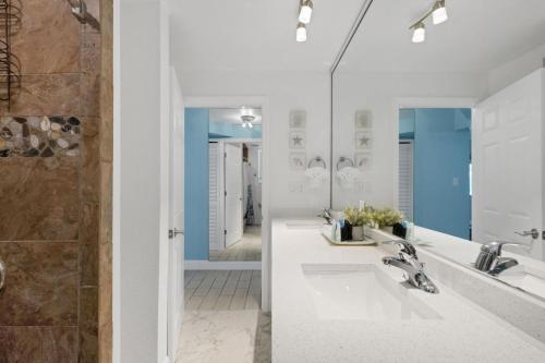 a bathroom with two sinks and a shower at Clearwater Beach Suites #102 in Clearwater Beach