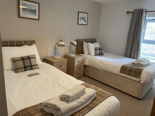 En eller flere senge i et værelse på Raven Wing 11 - Kintail Apartment